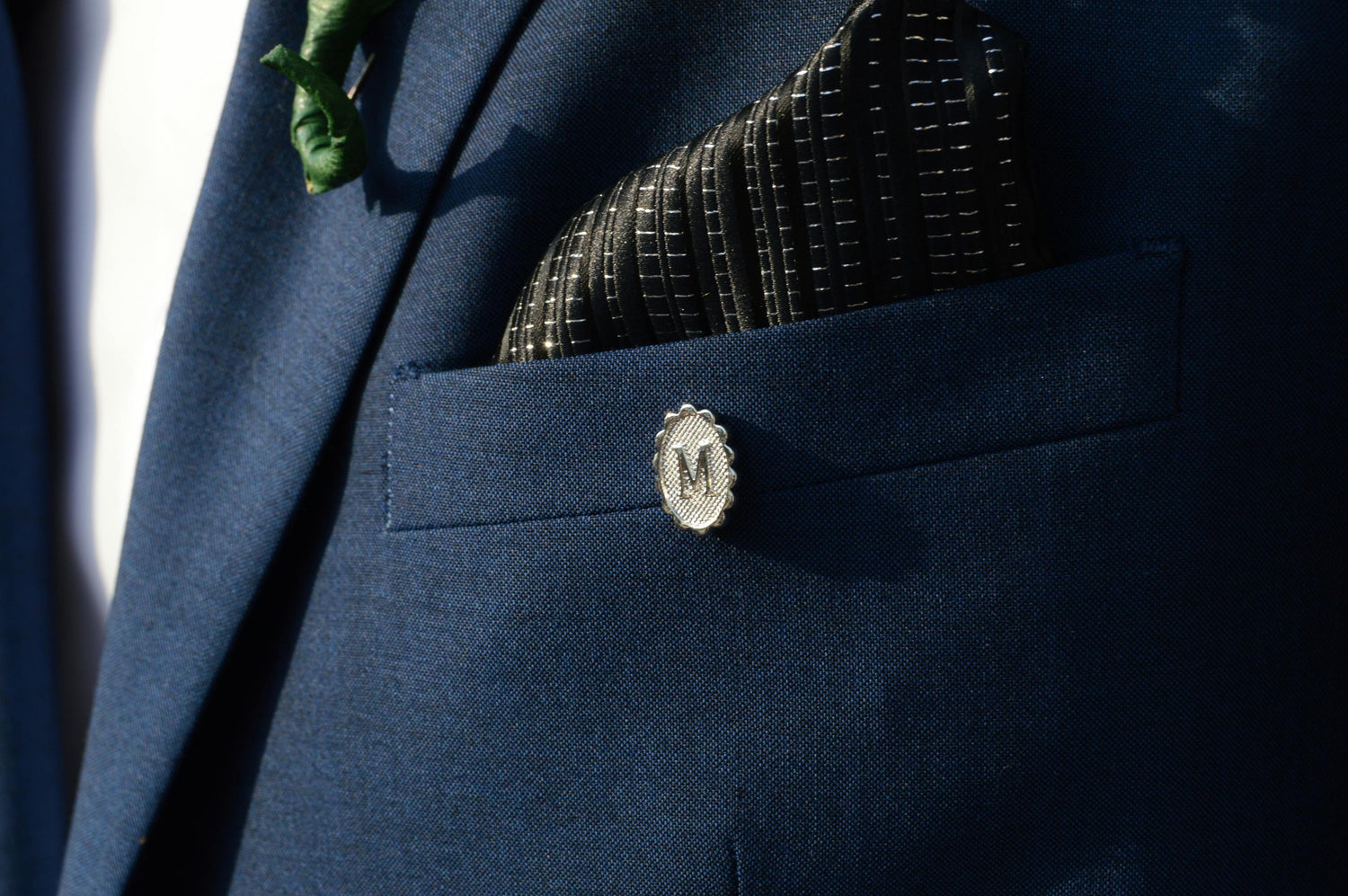 Navy suit jacket with handkerchief in breat pocket. 